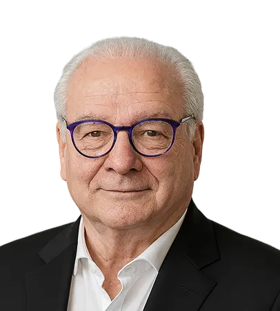 Professional portrait of a senior businessman in glasses, wearing a black suit and white shirt, smiling confidently.